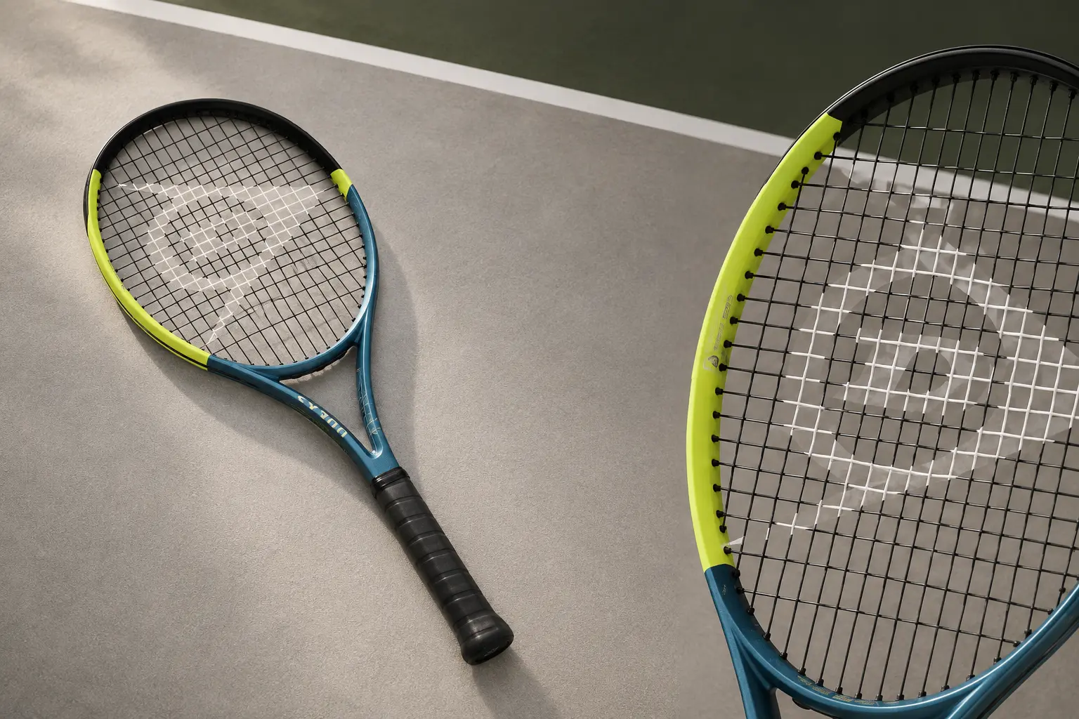 Illustration of a petrol blue, black and yellow Dunlop SX 300, showing the full racket and a close-up of the hoop.